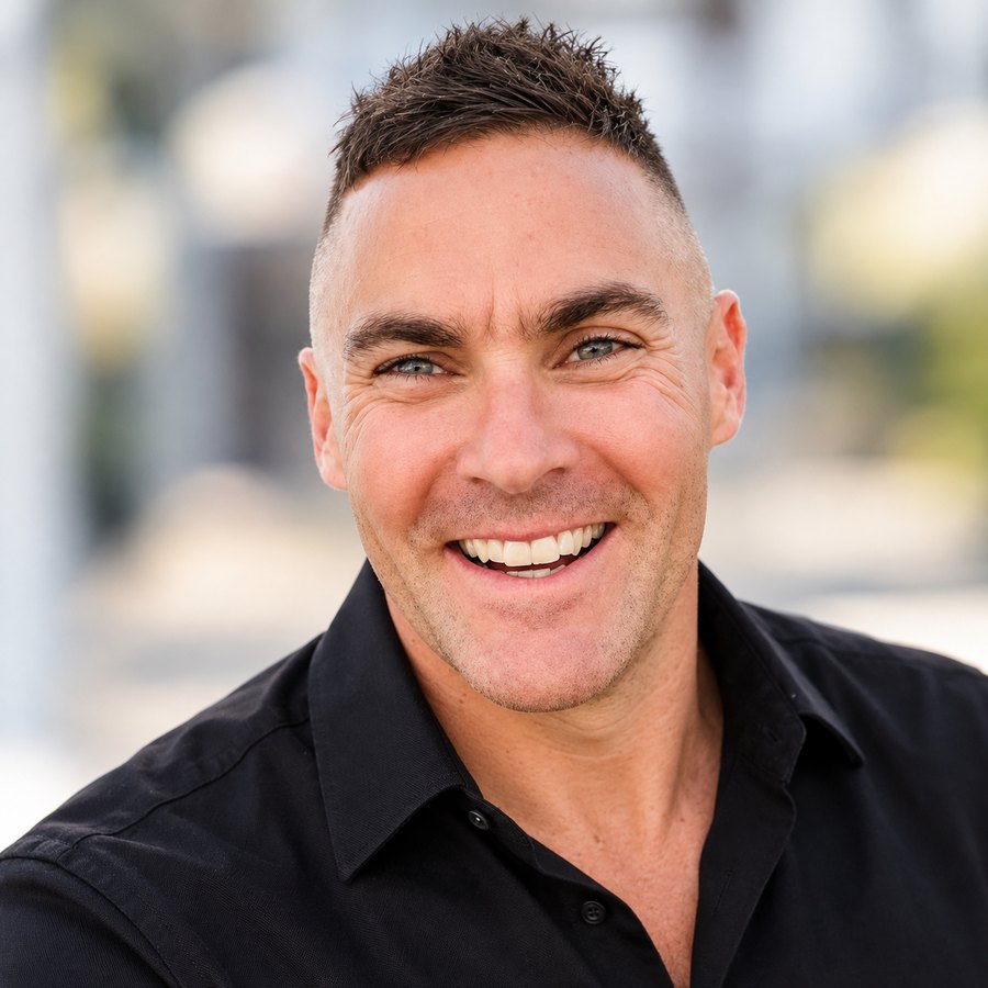 Portrait of Matthew Cassella, smiling, in a black shirt